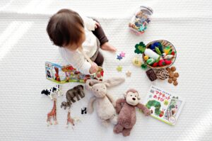 a young toddler surrounded by math resources that will develop his number sense